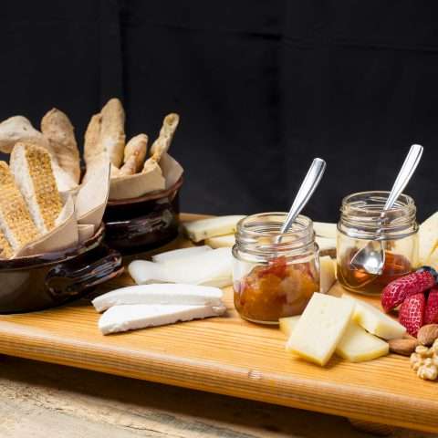 Chopping board of local cheeses and cottage cheese